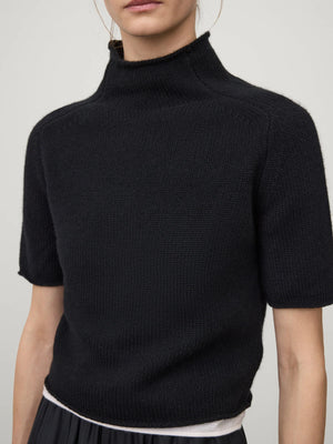 Lifestyle shot of the Fride Sweater in Black by Lisa Yang styled with casual wear, perfect for transitional seasons.