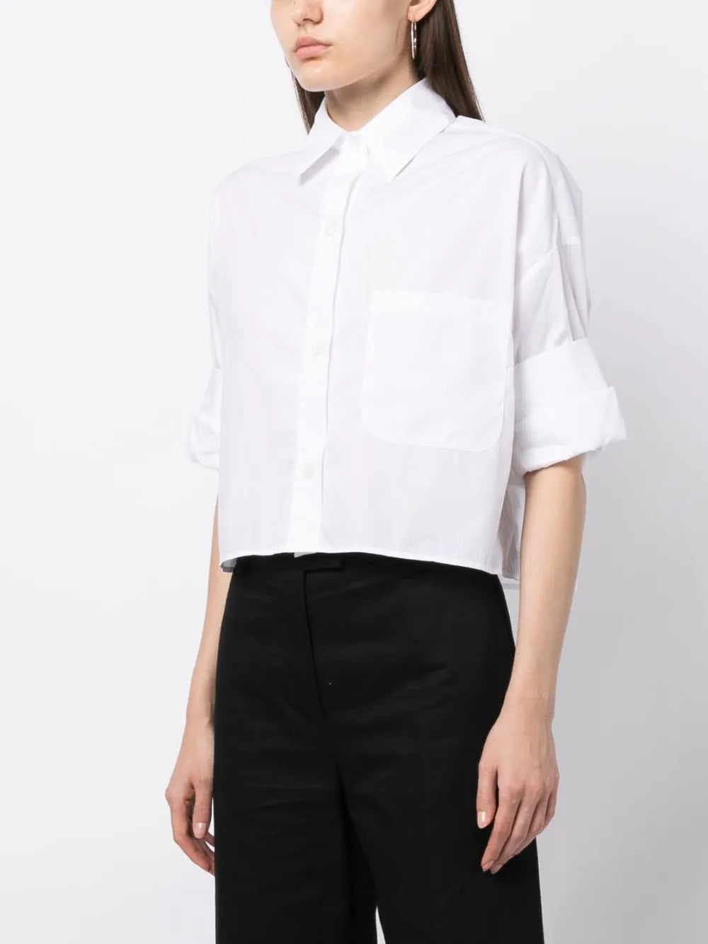 The signature features of TWP's Next Ex in White include a chest patch pocket and double roll button cuffs.