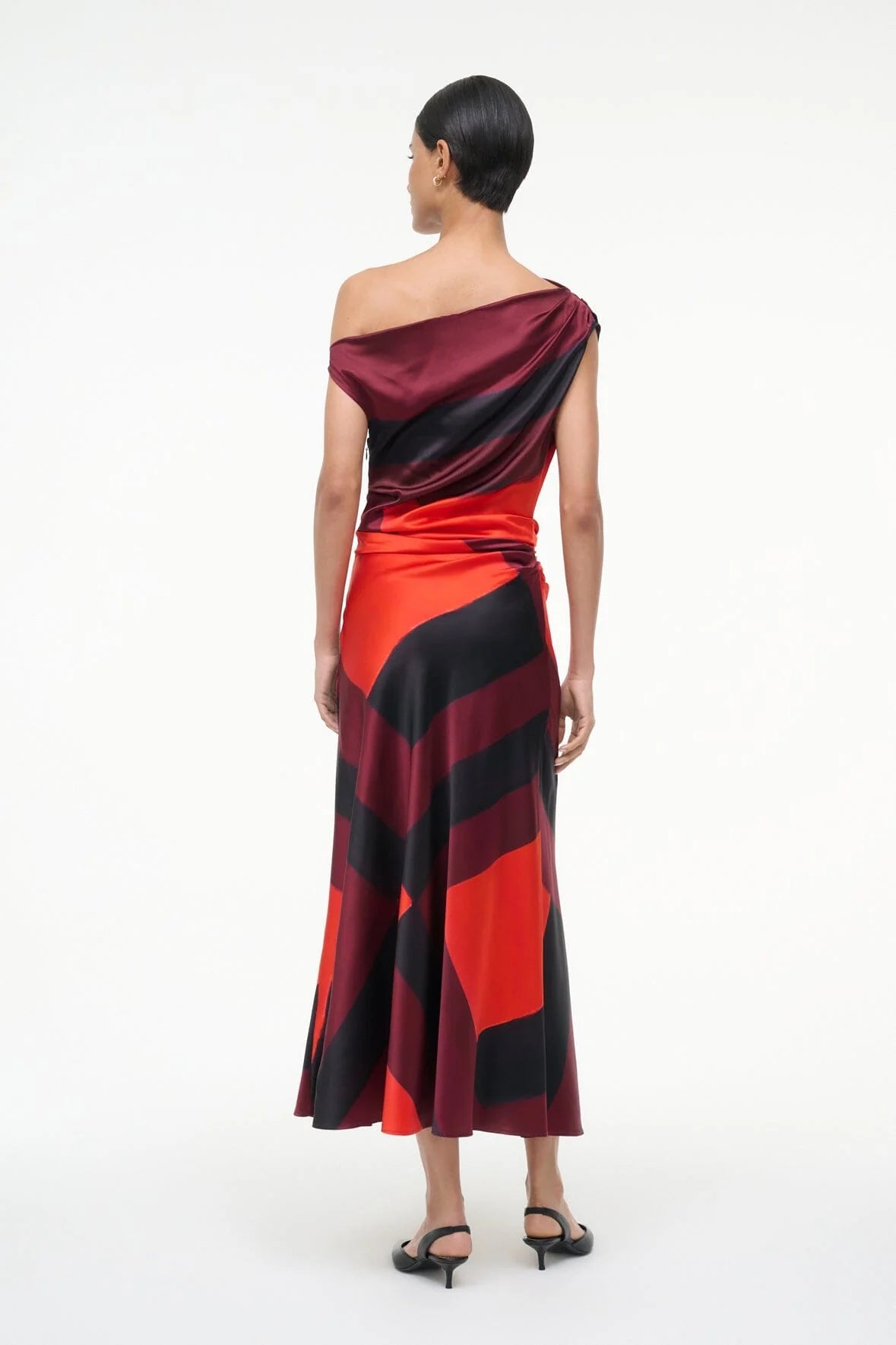Side profile of the Staud Phare Silk Dress in Ruby Prism emphasizing the stylish draping.