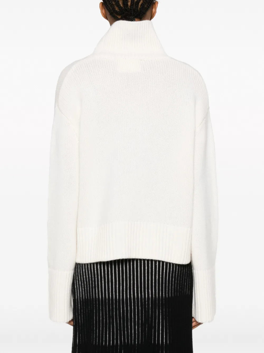 Model wearing the Fleur Sweater in Cream, styled for a chic casual outfit.