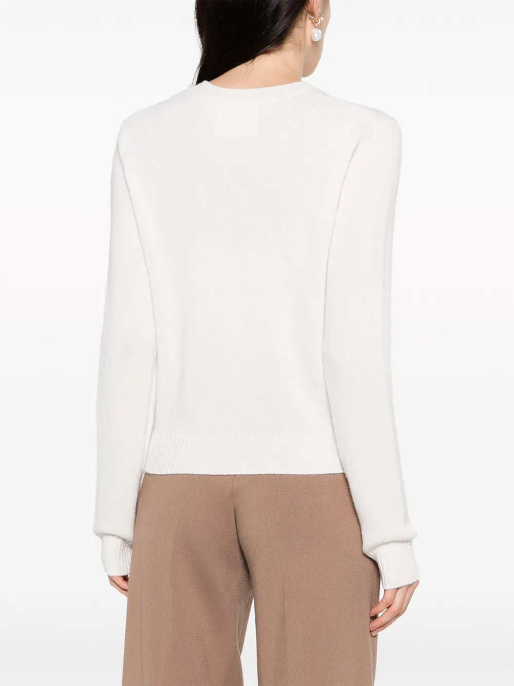 Mable Sweater in Cream displayed on a hanger, emphasizing its elegant silhouette and color.