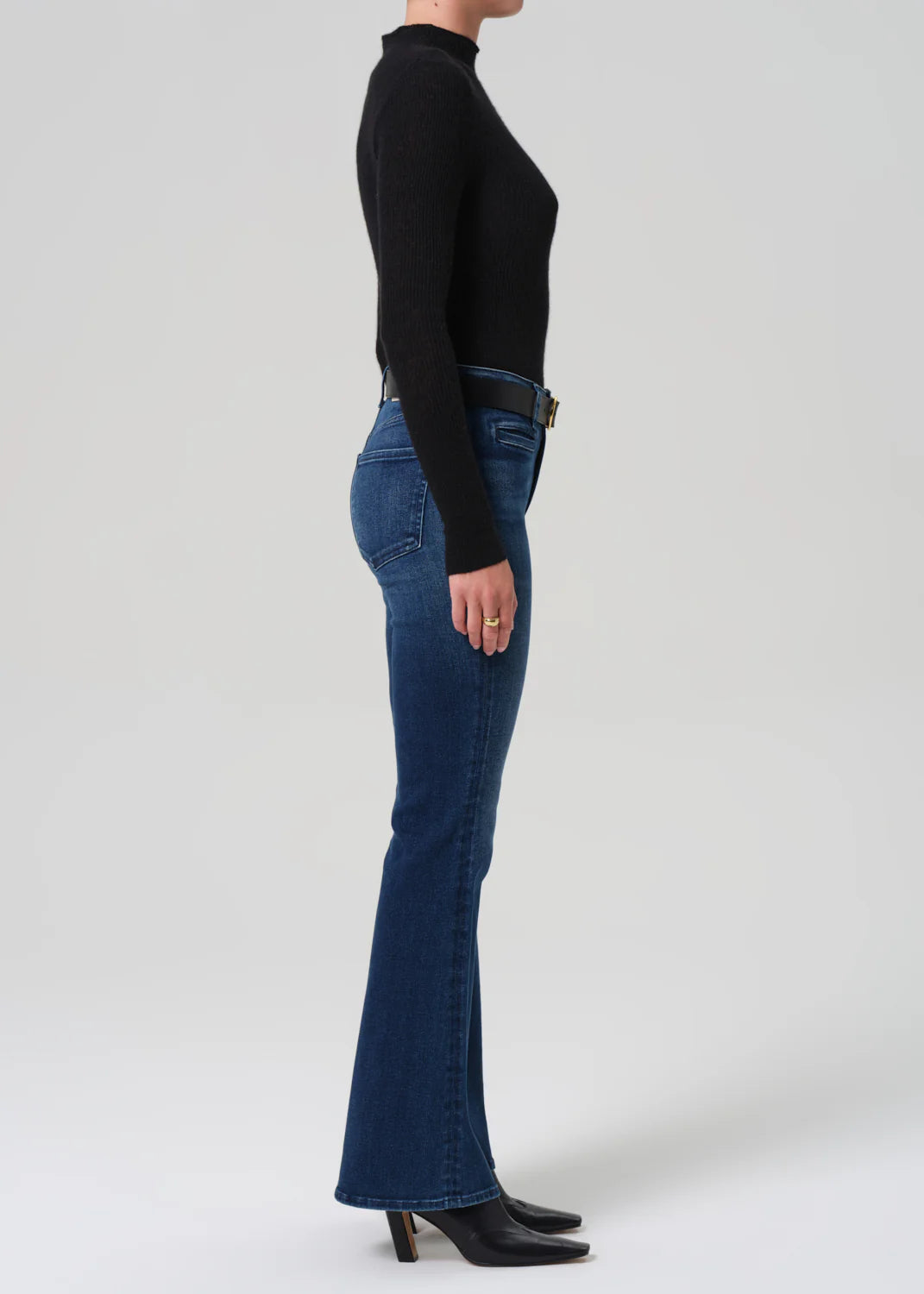 Model wearing the Lilah Welt Pocket Flare in Marvita, paired with a leather boot for a chic look.