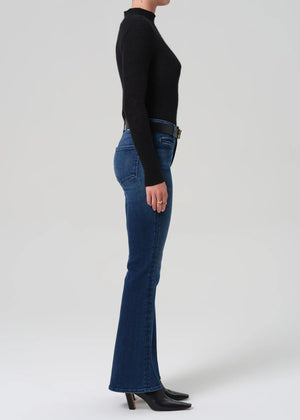Model wearing the Lilah Welt Pocket Flare in Marvita, paired with a leather boot for a chic look.