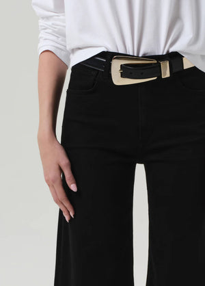 Lyra Long Wide Leg in Plush Black paired with sharp heels, illustrating its elegant transition from daywear to evening attire.