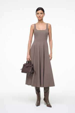 Side angle of Staud Wells Dress in Houndstooth showcasing its elegant silhouette and fitted design