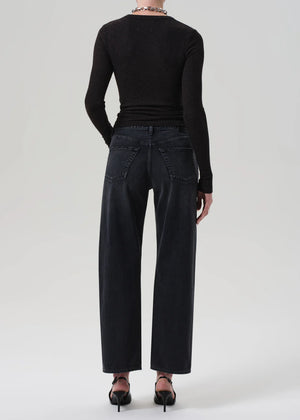 Woman wearing Lindz Easy Straight jeans in Vintage Black paired with stylish boots, demonstrating versatility.