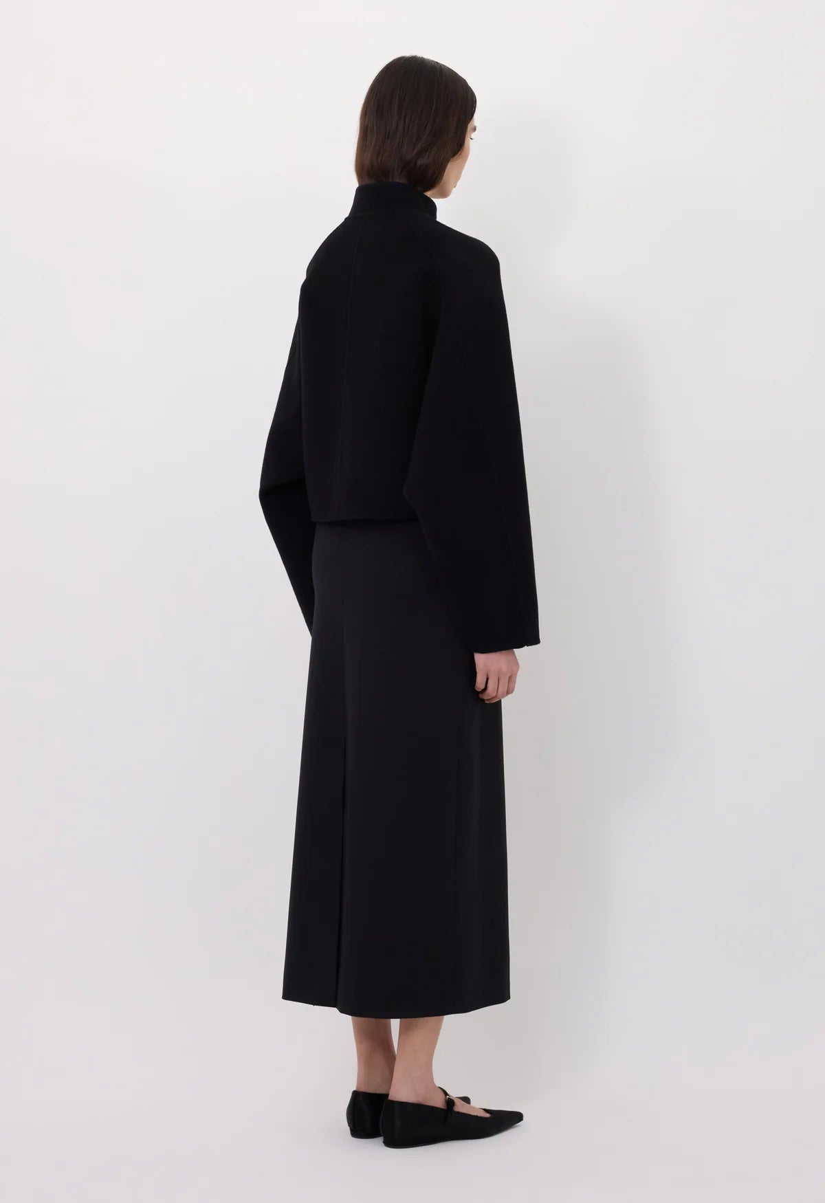 Detailed view of the Nyma Jacket in Black emphasizing the graphic silhouette created by its design.