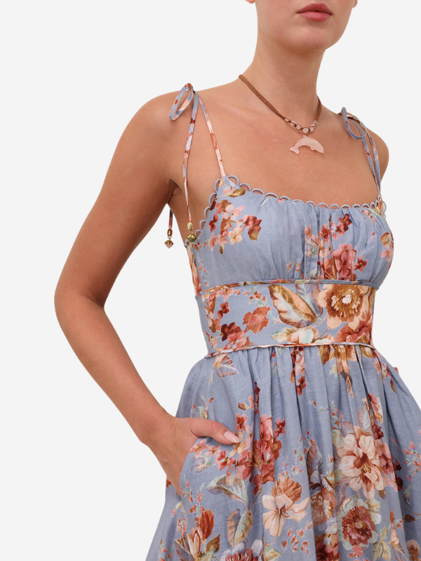 Full length model shot of the Awaken Picnic Dress in Chambray Floral worn at a sunny picnic setting.