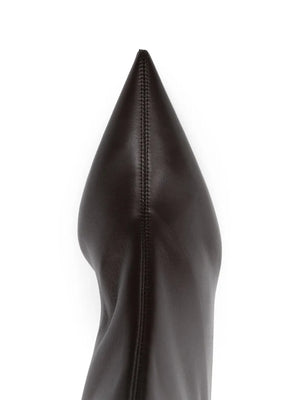 Nappa Heeled Sock Boot in Bark by TOTEME displayed in a chic setting, highlighting its modern design and versatility with jeans.