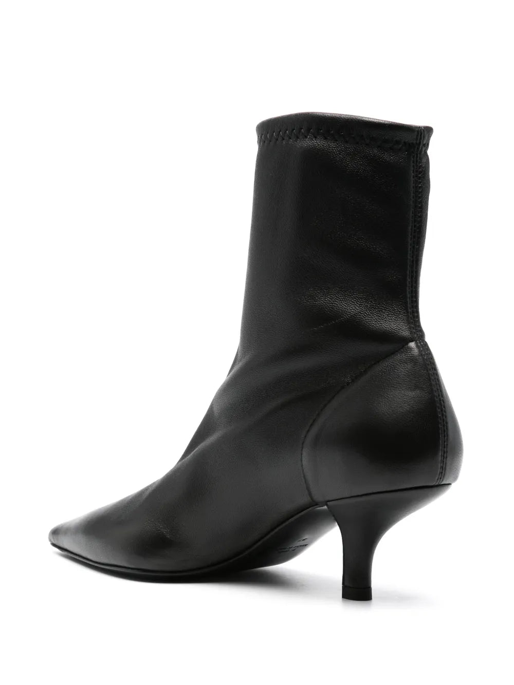 Fashionable Nappa Heeled Sock Boot in Black styled with trousers for a chic office look by TOTEME.