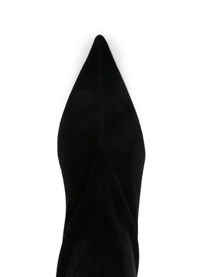 Suede Heeled Sock Boot in Black styled with jeans, perfect for an after-dark outing.