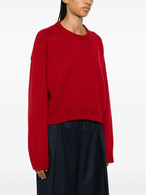 Stylish model wearing the Bruzzi LDS Crop Sweater in Red, perfectly pairing luxury comfort and fashion from Loulou de Saison.