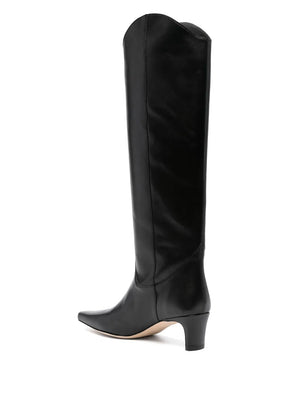 Side view of Western Wally Boot in Black by Staud, highlighting the curved topline and trendy silhouette.