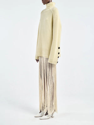 Close-up of the Primrose Yellow Button Mock Neck Sweater showcasing 3 signature corozo nut buttons at the cuff.