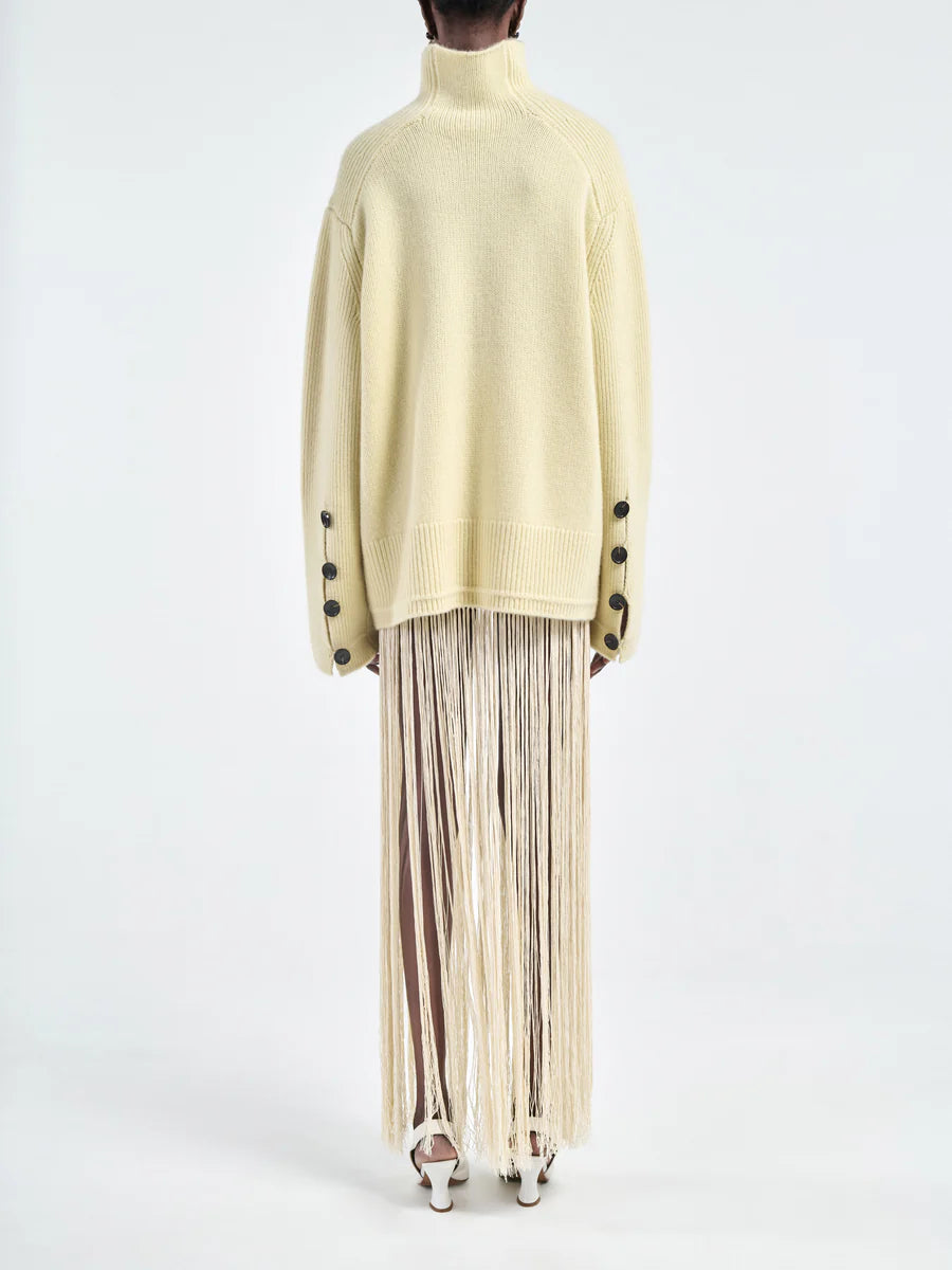 Relaxed fit of the Button Mock Neck Sweater in Primrose Yellow worn casually.