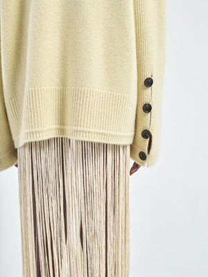The Primrose Yellow Button Mock Neck Sweater displayed against a stylish backdrop.