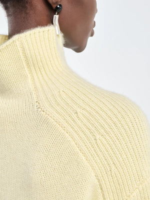 Full view of the Button Mock Neck Sweater in Primrose Yellow showcasing its elegant design.