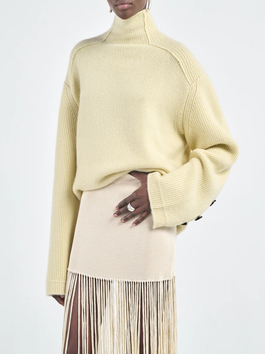 Detail shot of ribbed sleeves on the Primrose Yellow Mock Neck Sweater by Maria McManus.
