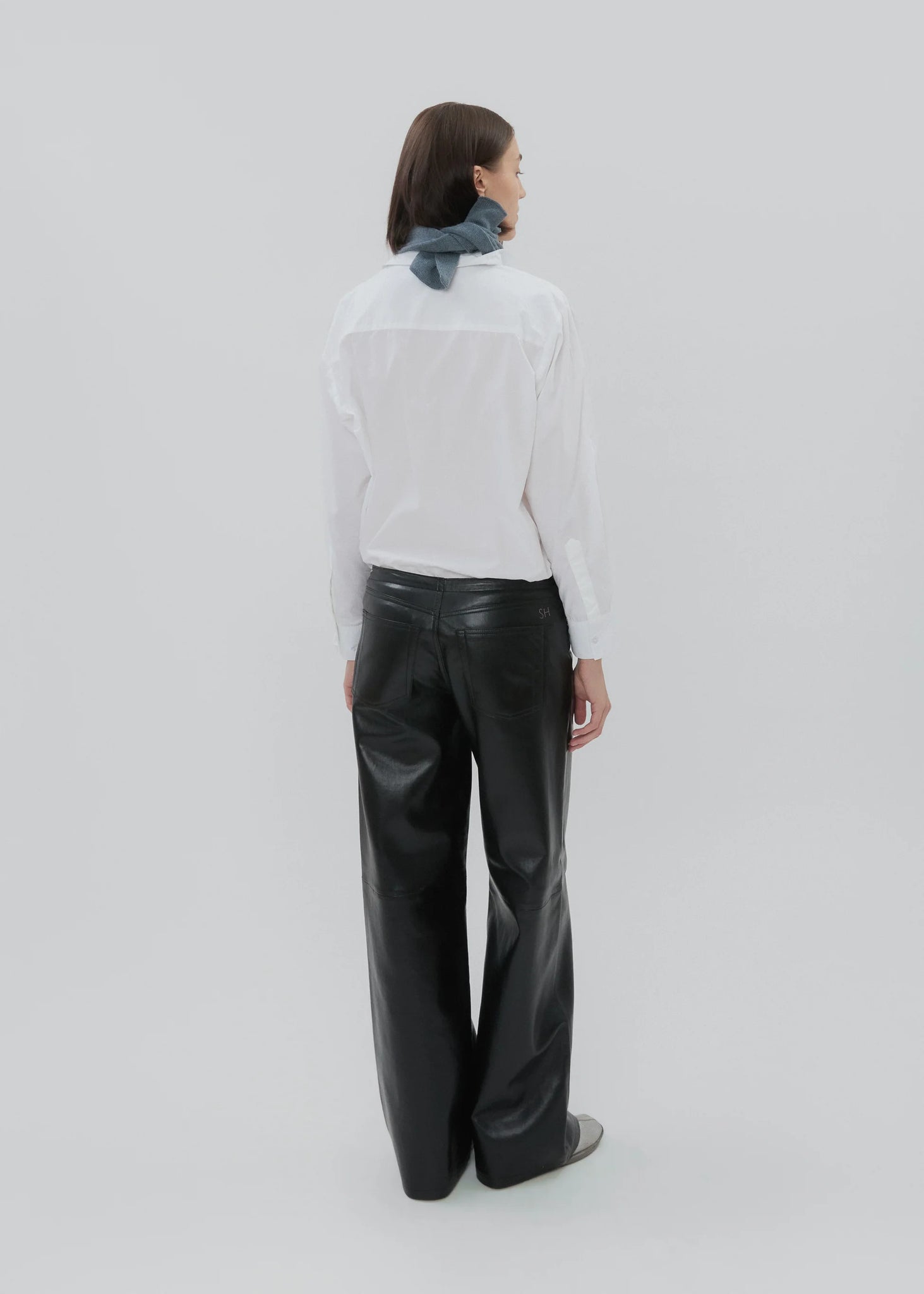 Back view of the Cool Jean in Black Leather featuring signature 'SH' embroidery.