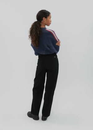 Model wearing the Everyday Jean in Black by Still Here, styled for day-to-night versatility.