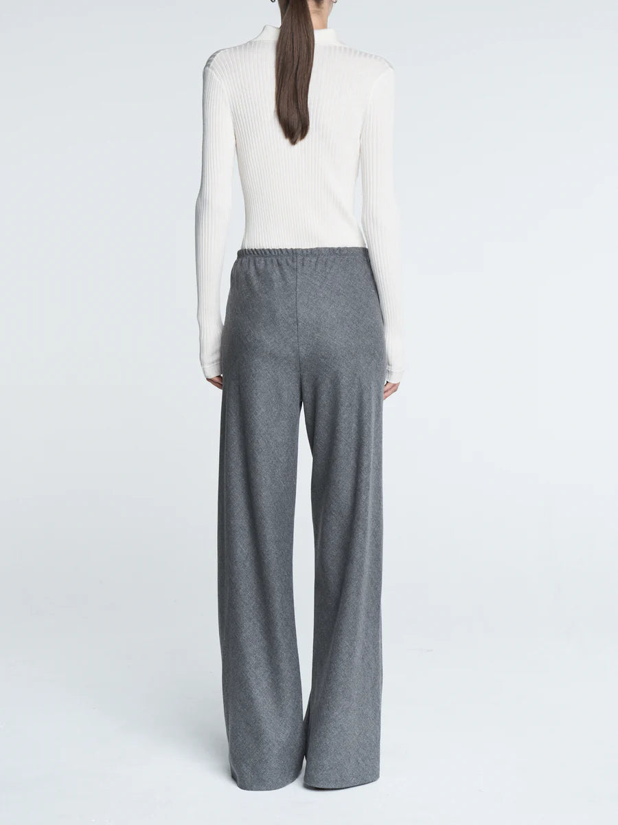 Model wearing Bias Cut Trousers in Heather Grey, demonstrating the easy fit and stylish design.