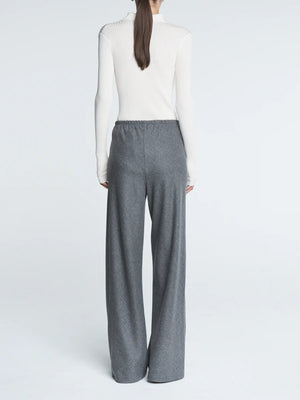 Model wearing Bias Cut Trousers in Heather Grey, demonstrating the easy fit and stylish design.