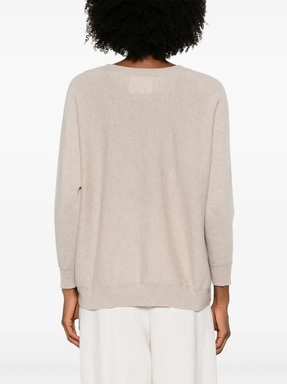 Kenny Sweater in Sand draped casually over shoulders, demonstrating its versatility and relaxed fit.