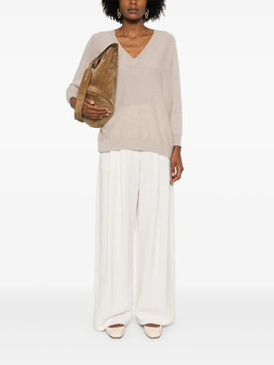 Side view of the Kenny Sweater in Sand, showcasing the soft cashmere texture and stylish slouchy design.