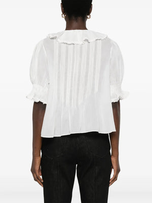 Flat lay of Dôen Henri Top in Salt on a textured background, emphasizing its organic cotton material.