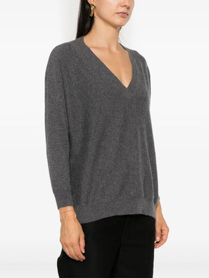 Kenny Sweater in Graphite styled casually over the shoulders, highlighting the relaxed fit and luxurious cashmere.
