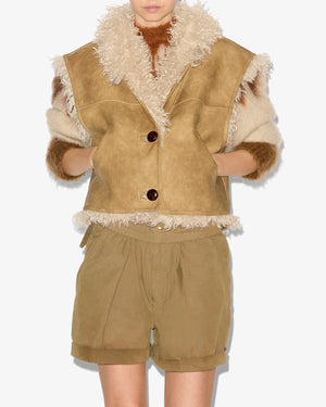Model wearing the Clara Vest in Taupe, highlighting its cropped cut and cozy design.
