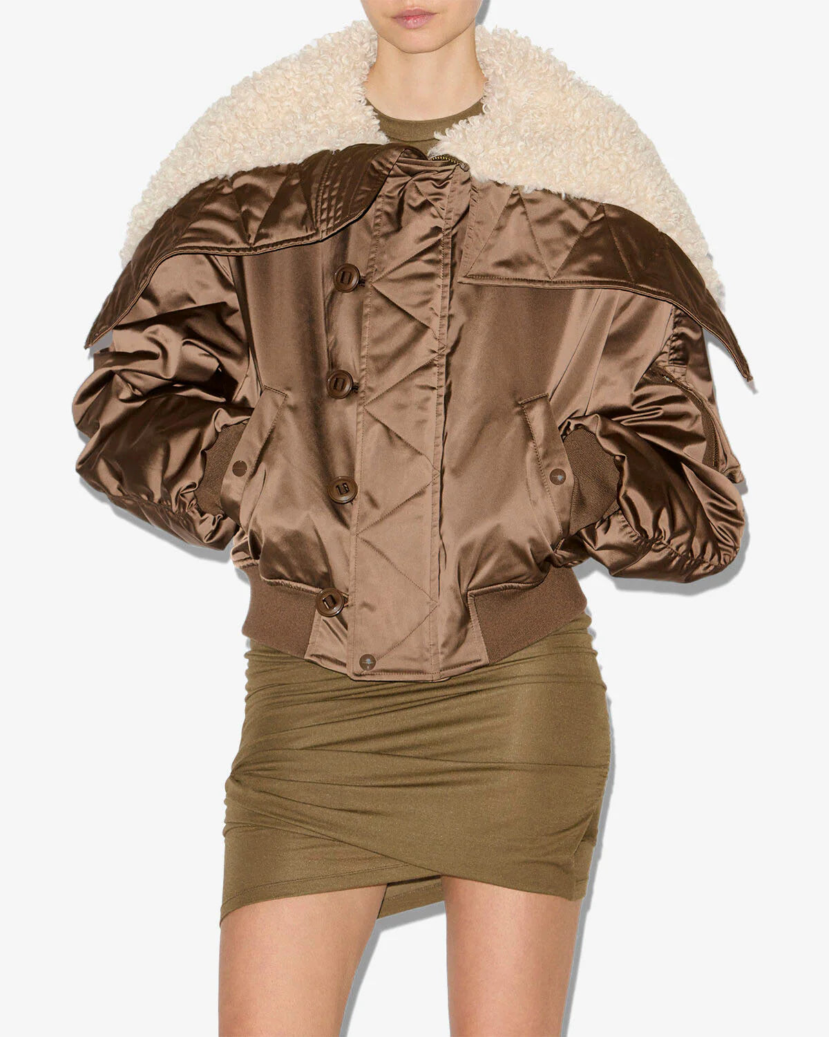A shot of the Elisa Coat in Khaki featuring snap-fastened pockets and long gathered sleeves by Isabel Marant.