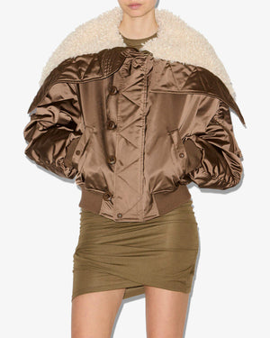 A shot of the Elisa Coat in Khaki featuring snap-fastened pockets and long gathered sleeves by Isabel Marant.