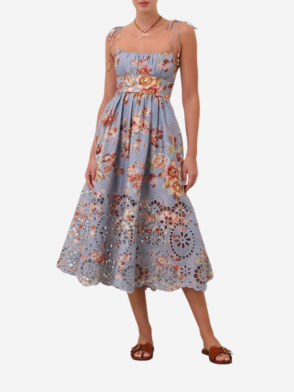 Close-up view of the embroidered detailing on the flared skirt of the Awaken Picnic Dress in Chambray Floral.