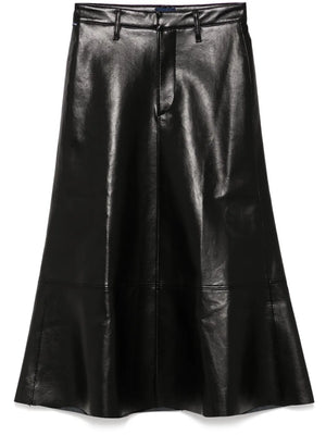 Cassia Leather Skirt in Black showcased on a model, highlighting the sleek A-line design and luxe recycled leather material.