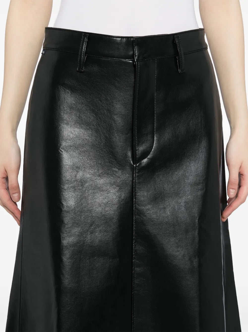 Cassia Leather Skirt in Black on a hanger, showcasing the timeless black color and modern design.