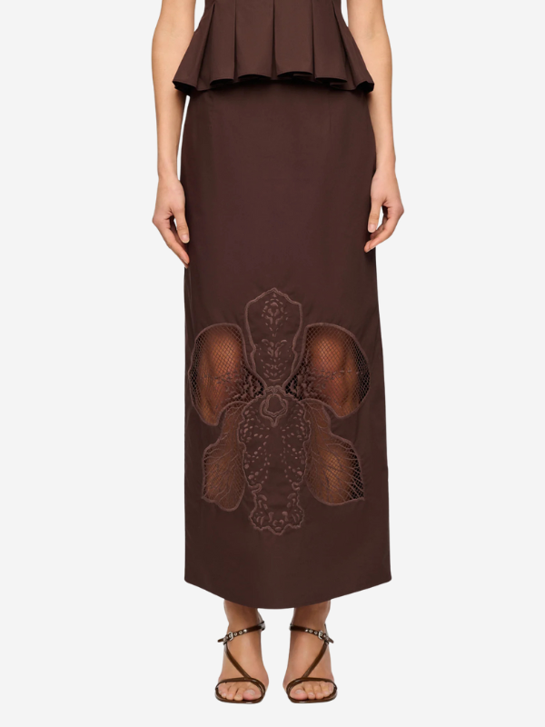 Model wearing the Leonie Skirt in Arabica, showcasing the beautiful orchid embroidery and cutwork hem detail.