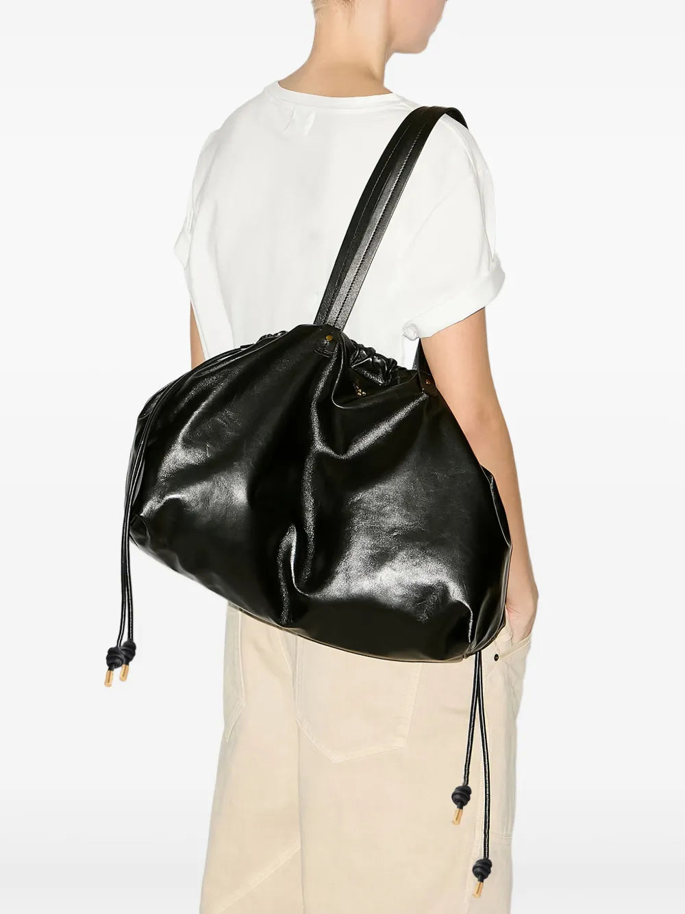 Close-up view of Silven E/W Bag in Black featuring the embossed Isabel Marant logo and gold-finish metal details.