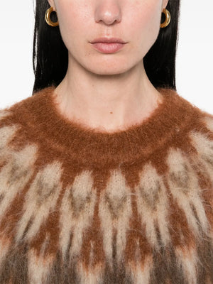 Natania Sweater in Rust displayed on a hanger showcasing the beautiful color and texture of the mohair blend.