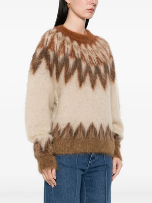 Model wearing the Natania Sweater in Rust featuring its stylish design and cozy fit, ideal for casual outings.