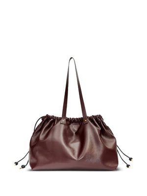 Isabel Marant's Silven E/W Bag in Burgundy with leather string and sliding system, perfect for shoulder or hand carry.