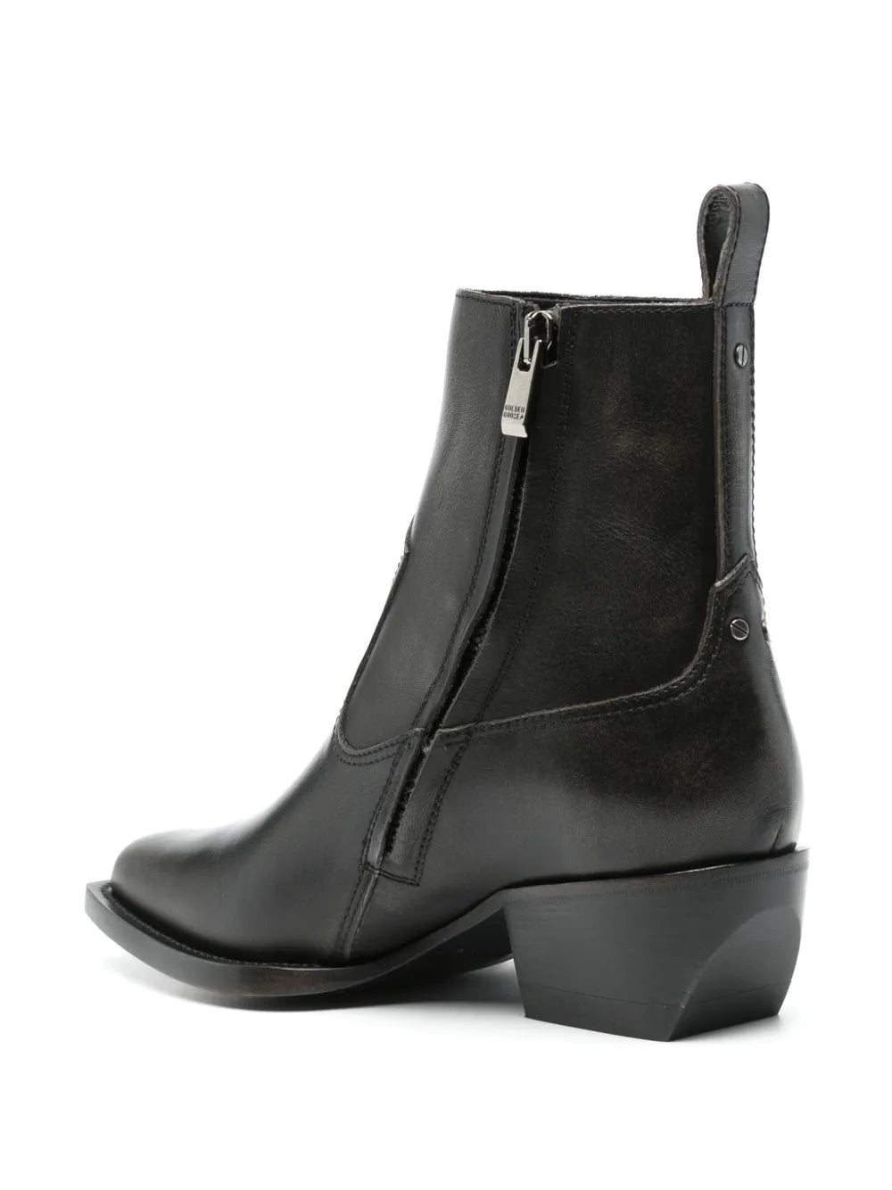 Close-up of the metal stud detail and gold-plated Golden Goose signature plaque on the heel of Debbie Ankle Boot in Black.