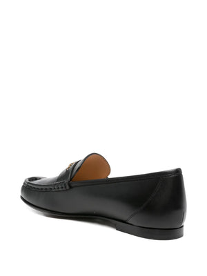 Close-up of Chloé Loafer in Black featuring the gold-tone Chloé logo chain, adding a luxurious touch to classic footwear.