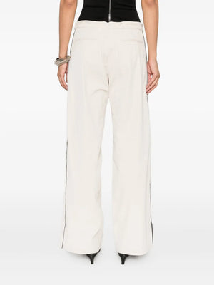 Side view of St. Agni's Tailored Track Pants in Putty, illustrating the stylish design and eco-friendly materials including recycled nylon and organic cotton.