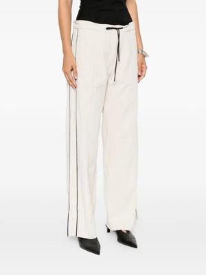 Full view of the Tailored Track Pants in Putty by St. Agni, featuring a mid-rise waist, ideal for elevated everyday wear and modern fashion.