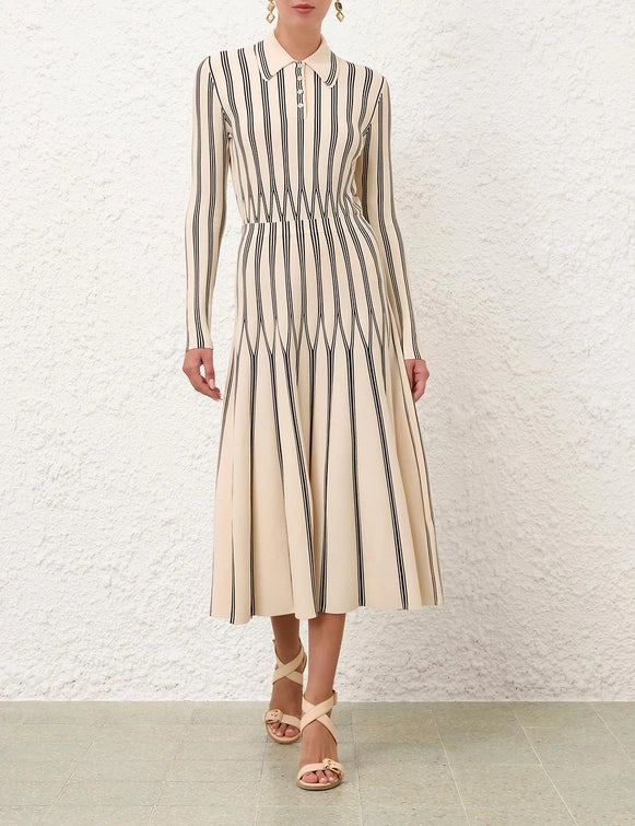Side view of the Rebellion Striped Midi Skirt in Cream Stripe highlighting its pleats and elegant silhouette.