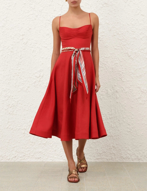 Stylish view of the Rebellion Tuck Midi Dress in Red, highlighting adjustable straps and full flare skirt.