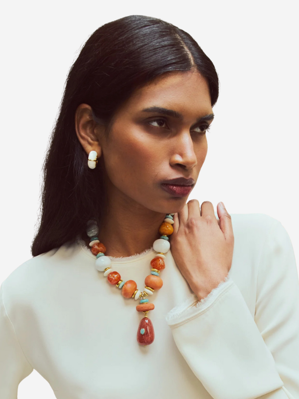 Close-up of Andamento Necklace in Mandarina with unique handmade clay beads in celadon, ivory, and terra cotta shades.