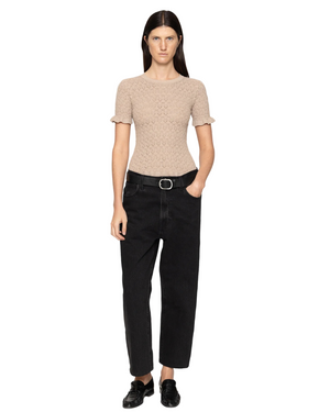 The elegant Ruby Top in Champagne displayed on a model, showcasing its fine gauge knit and stylish design.