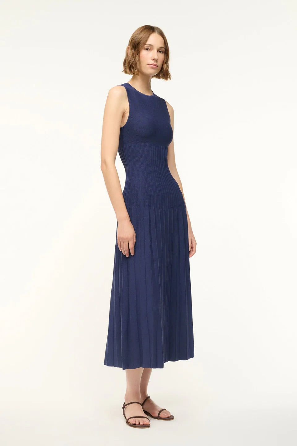 Model wearing the Elyse Dress in Navy with a chic look, perfect for casual outings or special occasions.